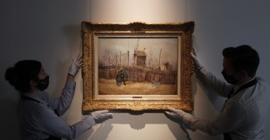 Sotheby's personnel display the "Street scene in Montmartre" painting by Dutch master Vincent Van Gogh at Sotheby's auction house in Paris, France, Feb. 25, 2021. (AP Photo)