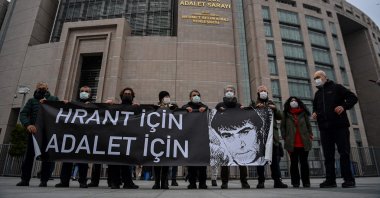 Demonstrators hold a banner reading "For Hrant, For Justice" with a drawing of Hrant Dink, outside the courthouse where the trial is being held, Istanbul, Turkey, March 26, 2021. (AFP Photo)