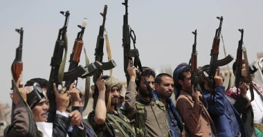 Tribesmen loyal to the Houthis raise their weapons during a protest against the agreement to establish diplomatic relations between Israel and the United Arab Emirates, in Sanaa, Yemen, Aug. 22, 2020. (AP Photo)