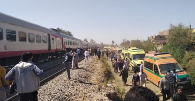 Medical staff and people inspect the damage after two trains collided near the city of Sohag, Egypt, March 26, 2021. (Reuters Photo)