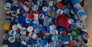 Plastic bottle caps in a box are seen in Caracas, Venezuela, March 04, 2021. (EPA Photo)