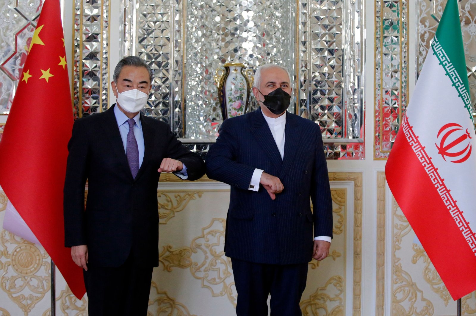 Iranian Foreign Minister Mohammad Javad Zarif (R) greets his Chinese counterpart Wang Yi, in Tehran, Iran, March 27, 2021. (AFP Photo)