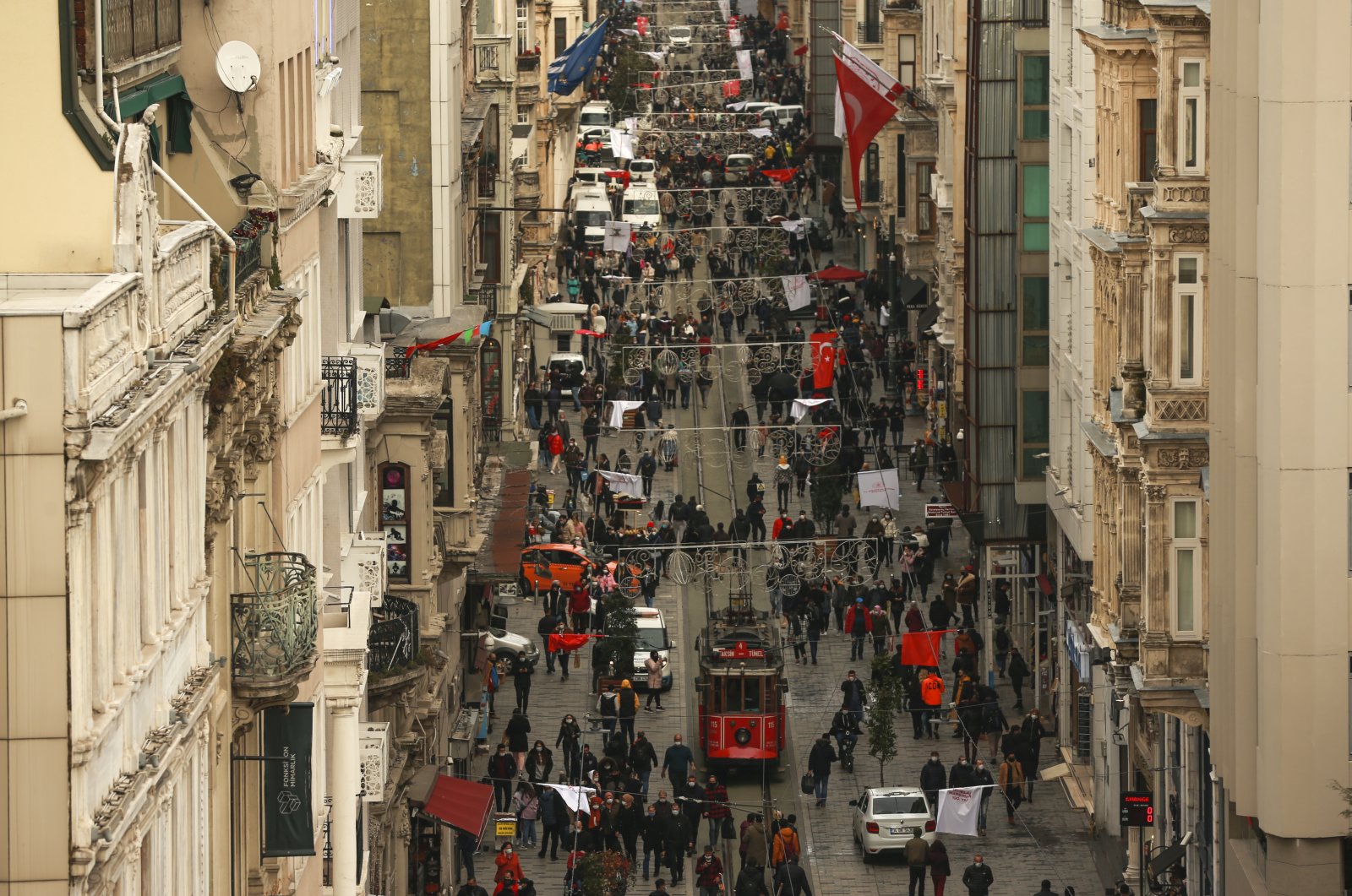 People walk on Istiklal street, the main shopping street of Istanbul, Turkey, March 25, 2021. (AP Photo)