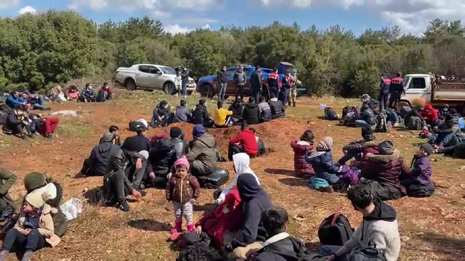 Irregular migrants wait to be processed after being rescued by Turkish Coast Guard in western Izmir province's Urla district on March 18, 2021 (IHA Photo)