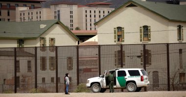 Migrants are detained by a U.S. Border Patrol agent after crossing the Rio Bravo river to turn themselves in to request asylum in El Paso, Texas, U.S., as seen from Ciudad Juarez, Mexico, March 27, 2021. (Reuters Photo)