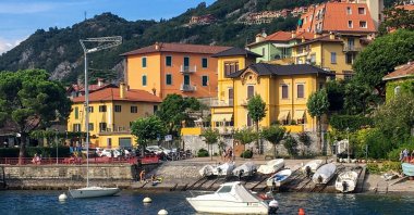 Boats and houses on Lake Como in the city of Varenna, Lombardy, Italy, Aug. 19, 2020. (AFP Photo)