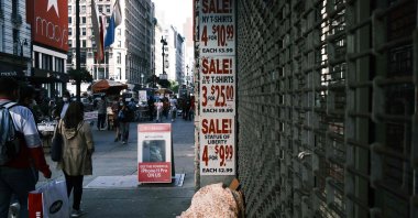 Signs advertise a sale in a New York City business, New York, U.S., Oct. 15, 2020. (AFP Photo)