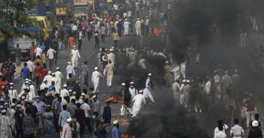 Activists of Bangladesh's Hefazat-e-Islam group burn tires to block traffic on the Dhaka Chittagong highway as they enforce a daylong general strike in Narayanganj, Bangladesh, March 28, 2021. (AP Photo)