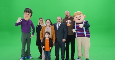 Industry and Technology Minister Mustafa Varank (C), his two children and "Rafadan Tayfa" producer Ismail Fidan (2nd R) pose with studio employees dressed as famous animated characters, Ankara, Turkey, March 28, 2021. (Photo by Industry and Technology Ministry via AA)