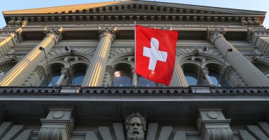 Switzerland's national flag flies at the Swiss Federal Palace (Bundeshaus), the seat of the parliament and the government, in Bern, Switzerland, March 18, 2021. (Reuters Photo)
