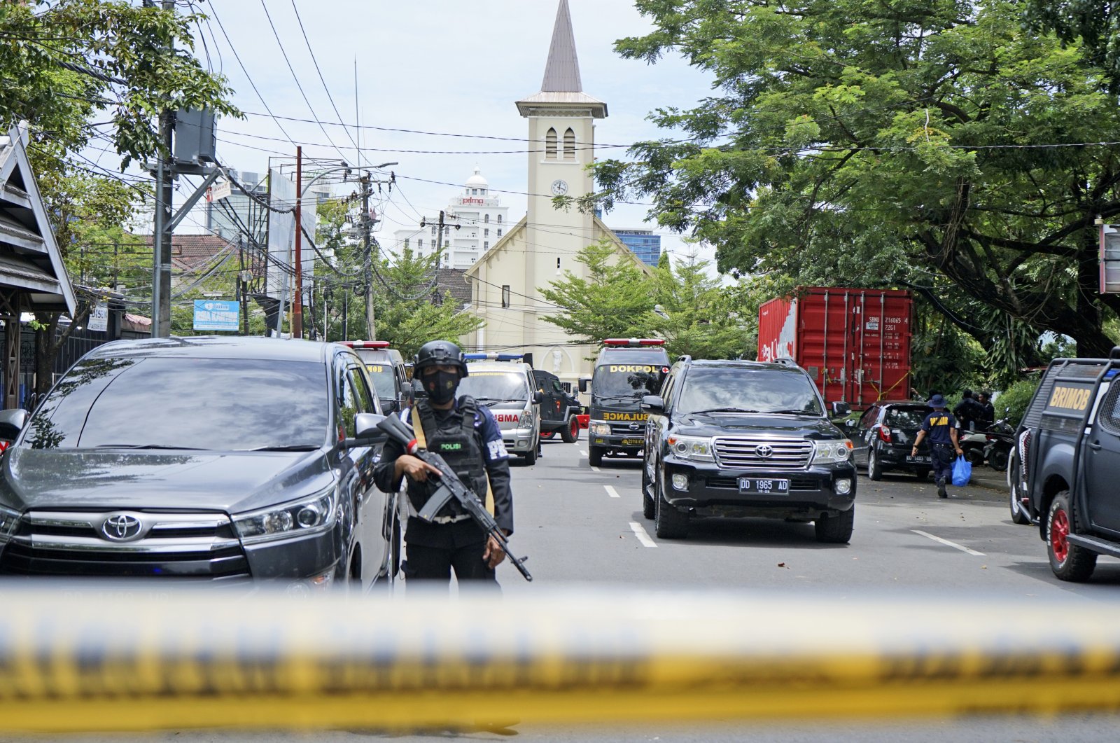 A police officer stands guard near a church where an explosion went off in Makassar, South Sulawesi, Indonesia, Sunday, March 28, 2021. (AP Photo)