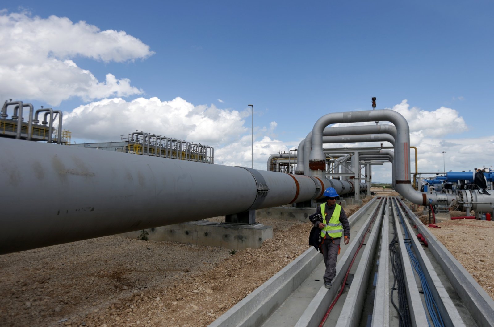 A local employee walks near a compressor station of the Trans Adriatic Pipeline (TAP) in Seman near Fier, Albania, April 11, 2019. (Reuters Photo)