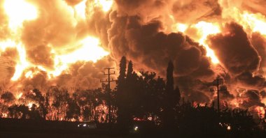 Thick smoke rises during a fire at a state-run Balongan oil refinery in Balongan, Indramayu, Indonesia, 29 March 2021. (EPA/STR Photo)
