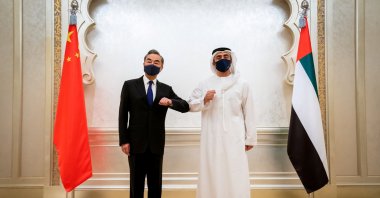 Chinese State Councilor and Foreign Minister Wang Yi (L) and UAE Foreign Minister Abdullah Bin Zayed Al Nahyan do an elbow shake during their meeting in Abu Dhabi, United Arab Emirates, March 28, 2021. (REUTERS Photo)