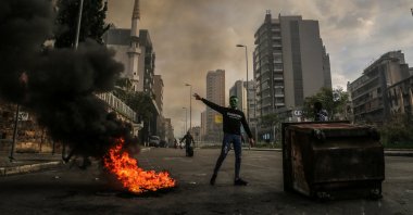 A protestor wearing a "Hulk" mask flashes the V-sign during a protest against Lebanese lira depreciation against the U.S. dollar on the black market, Beirut, Lebanon, March 4, 2021. (Photo by Getty Images)