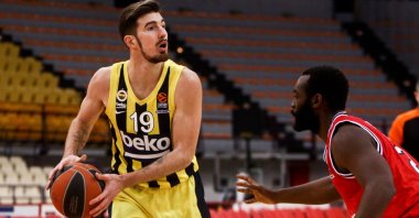 Fenerbahçe guard Nando De Colo (L) tries to pass the ball past Olympiacos Piraeus' Charles Jenkins during a EuroLeague match at the SEF Stadium in Piraeus, Greece, March 26, 2021. (EPA Photo)