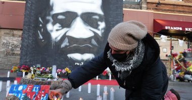 Community activists light candles at a memorial near the site where George Floyd died at the hands of former Minneapolis police officer Derek Chauvin in Minneapolis, Minnesota, U.S., March 28, 2021. (Getty Images/AFP Photo)