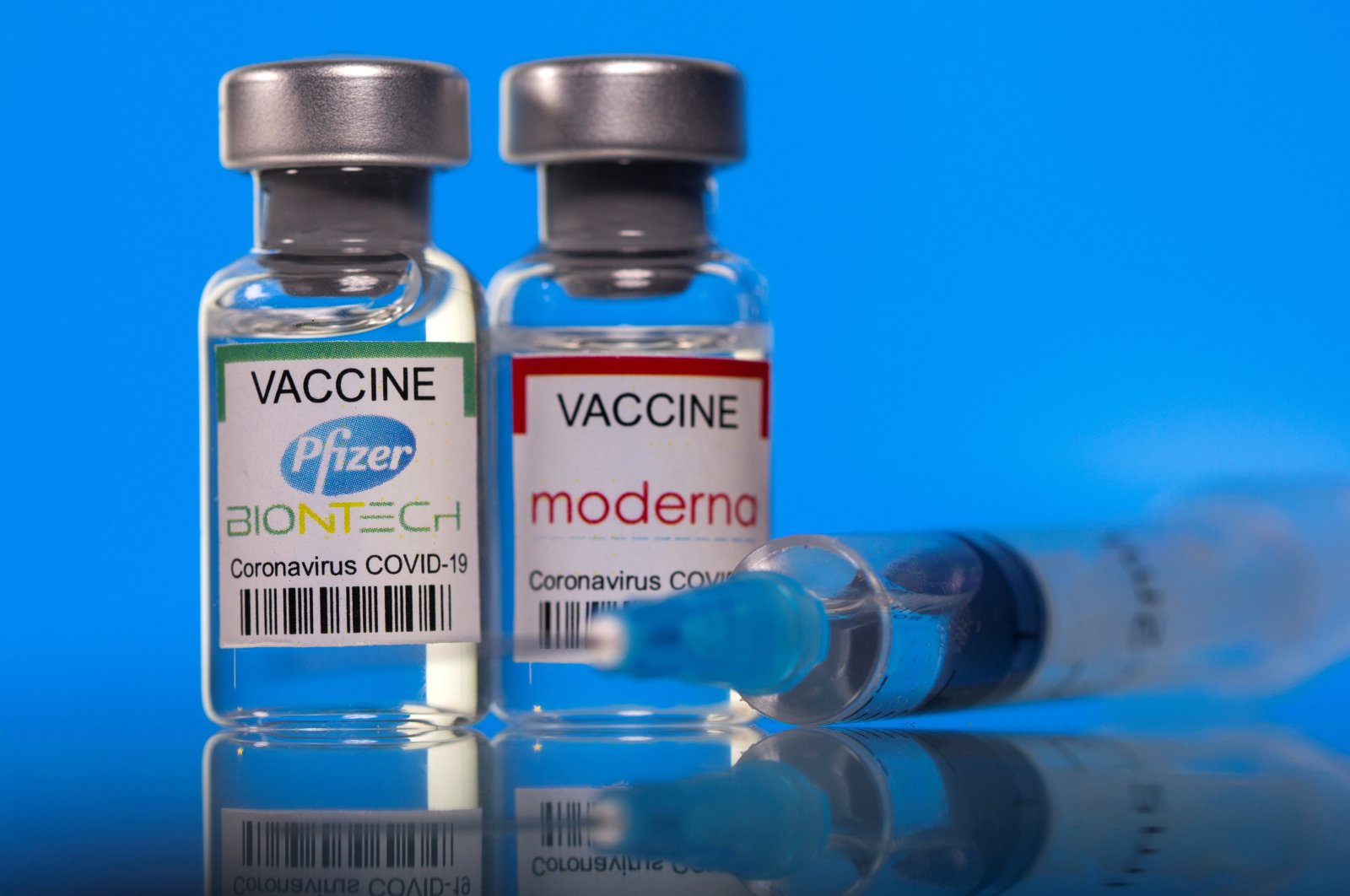 Vials with Pfizer-BioNTech and Moderna coronavirus disease (COVID-19) vaccine labels in this illustration picture taken March 19, 2021. (Reuters Photo)
