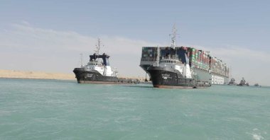 The Ever Given, a Panama-flagged cargo ship is accompanied by Suez Canal tugboats as it moves in the Suez Canal, Egypt, March 29, 2021. (Suez Canal Authority via AP)