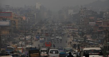 A wave of cars, motorcycles and pedestrians pass through a busy street during a smoggy day in Kathmandu, Nepal, March 30, 2021. (Reuters Photo)