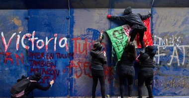 Demonstrators hang a Mexican flag during a protest after the death of Salvadoran migrant Victoria Esperanza Salazar, Mexico City, Mexico, on March 29, 2021. (AFP Photo)