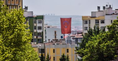 A Turkish national flag is hung between residential buildings in Ankara, Turkey, May 18, 2020. (Photo by Getty Images)