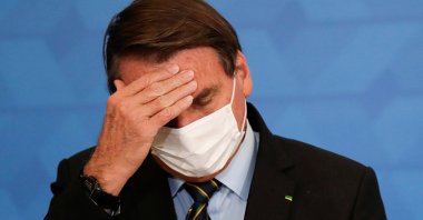 Brazil's President Jair Bolsonaro gestures during a ceremony to announce measures by Caixa Economica bank in support of philanthropic hospitals, in Brasilia, Brazil March 25, 2021. (Reuters Photo)