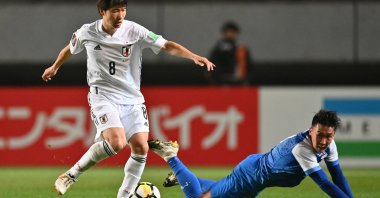 Japan's Sho Inagaki (L) competes for the ball with Mongolia's Amaraa Dulguun during the FIFA World Cup Qatar 2022 Asian zone Group F qualification match at Fuku-ari stadium, Chiba, Japan, March 30, 2021. (AFP Photo)