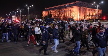 People march demanding an end to coronavirus restrictions, in Bucharest, Romania, March 30, 2021. (Inquam Photos / Octav Ganea via Reuters)