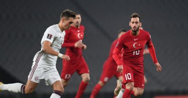 Latvia's forward Vladislavs Fjodorovs (L) runs with the ball in front of Turkey's midfielder Hakan Çalhanoğlu (R) during the FIFA World Cup Qatar 2022 qualification Group G football match between Turkey and Latvia at the Olympic Stadium, in Istanbul, on March 30, 2021. (AFP Photo)