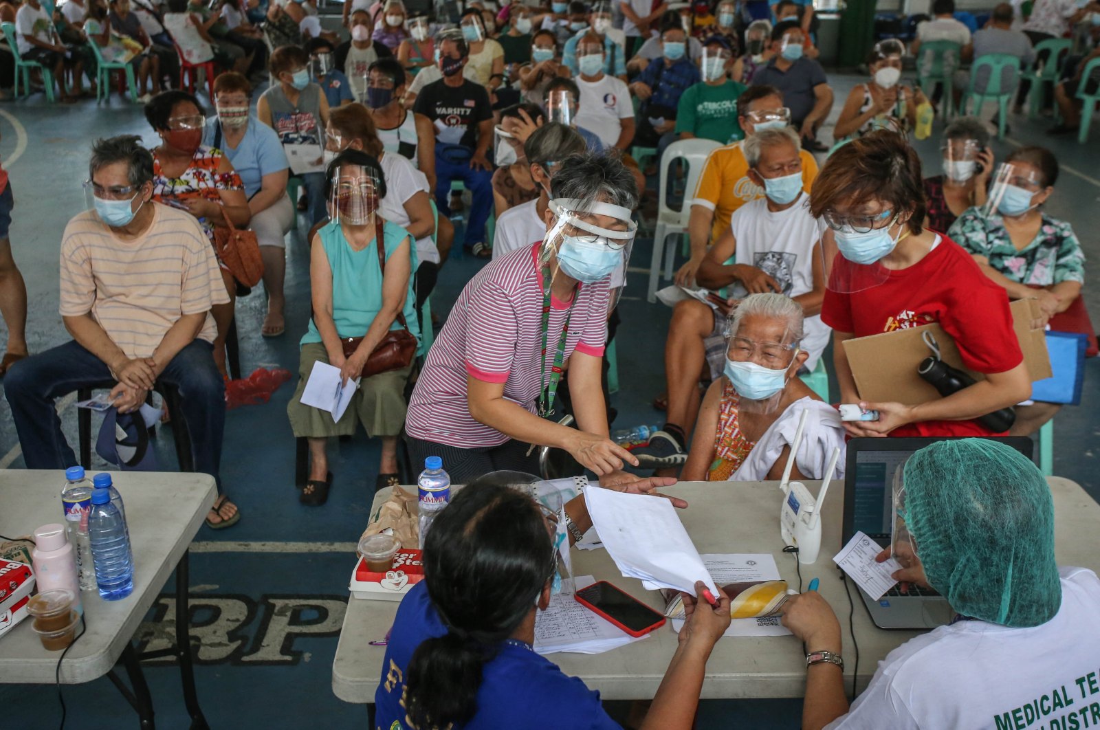 Elderly residents wait for their turn to get the AstraZeneca's vaccine against COVID-19 in Manila, Philippines, March 30, 2021. (AFP Photo)