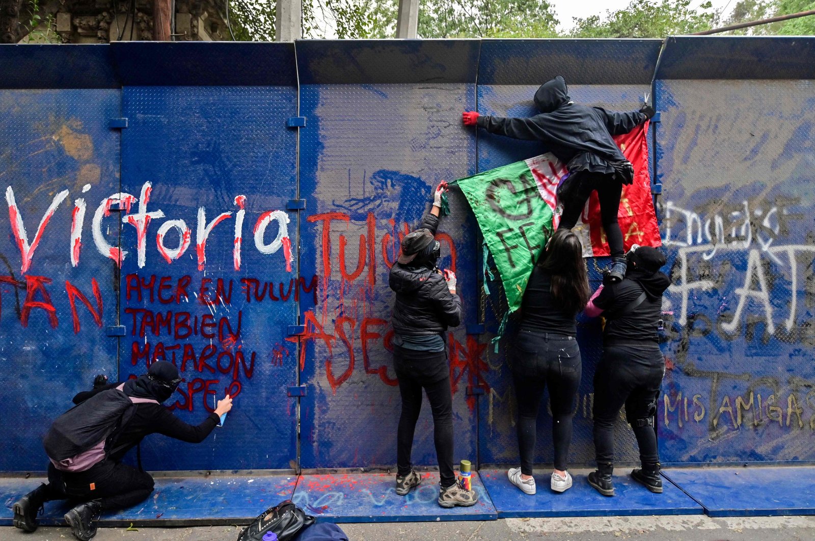 Demonstrators hang a Mexican flag during a protest after the death of Salvadoran migrant Victoria Esperanza Salazar, Mexico City, Mexico, on March 29, 2021. (AFP Photo)