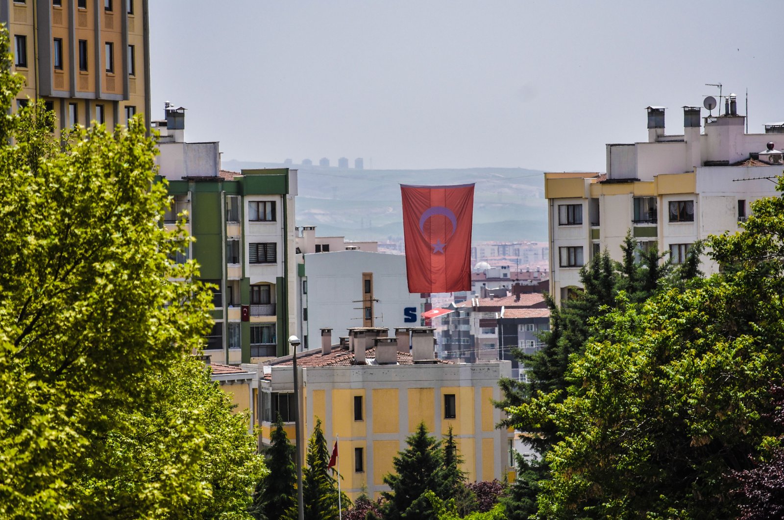 A Turkish national flag is hung between residential buildings in Ankara, Turkey, May 18, 2020. (Photo by Getty Images)