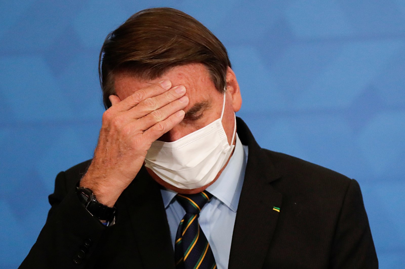 Brazil's President Jair Bolsonaro gestures during a ceremony to announce measures by Caixa Economica bank in support of philanthropic hospitals, in Brasilia, Brazil March 25, 2021. (Reuters Photo)