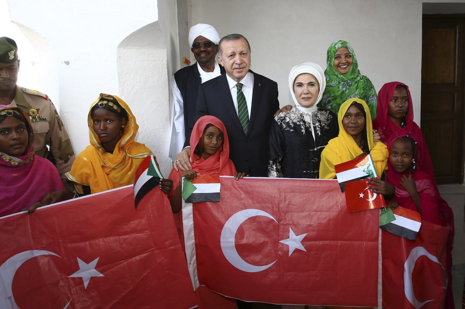 President Recep Tayyip Erdoğan and First Lady Emine Erdoğan pose with Sudanese children in Port Sudan, Sudan, Feb.1, 2018. (AA)
