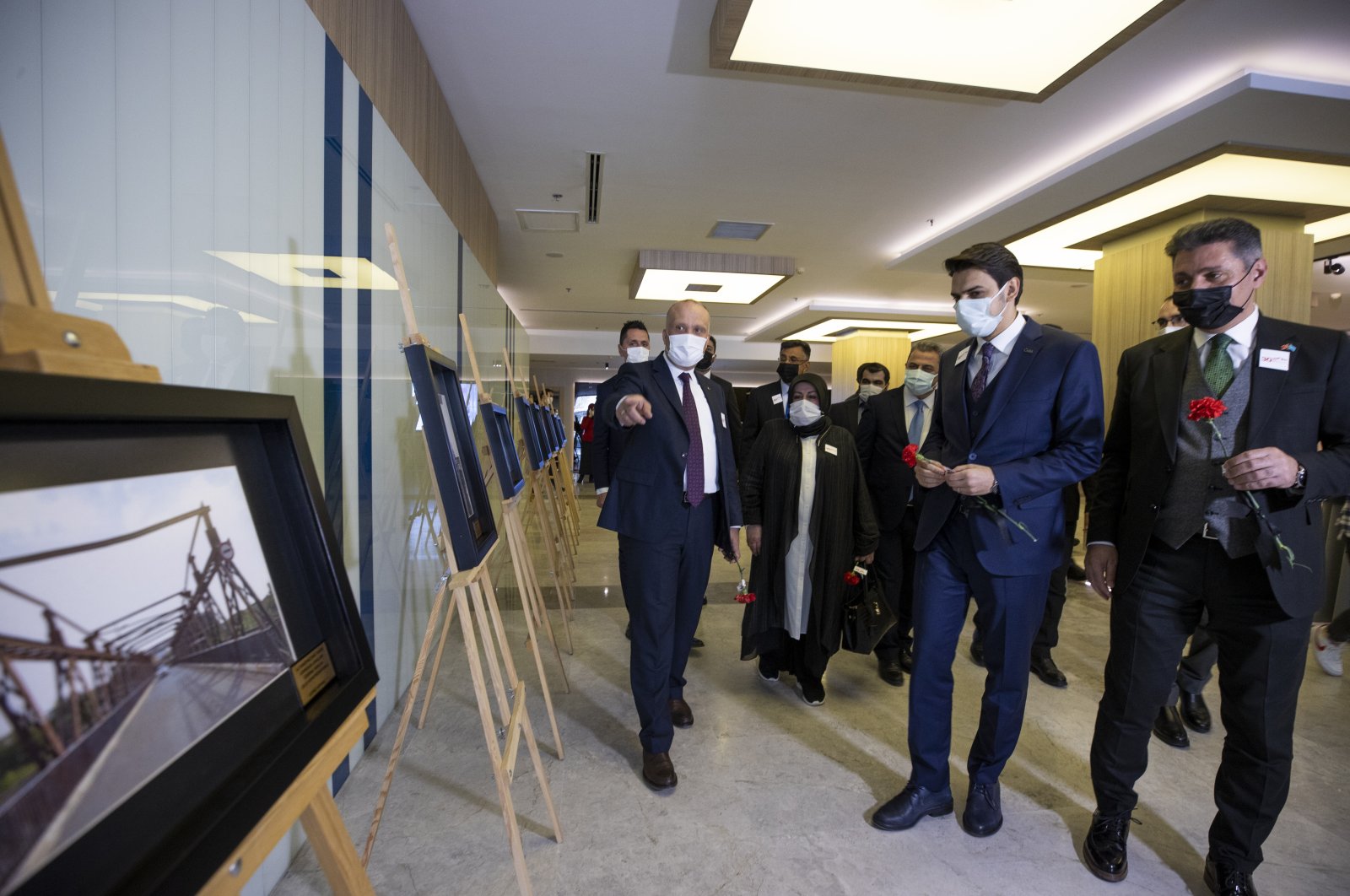 YTB President Abdullah Eren (R2) and ITF Turkey Representative Mehmet Tütüncü (R) visit Altun Köprü photograph exhibition, in Ankara, Turkey, on March 30, 2021. (AA Photo)