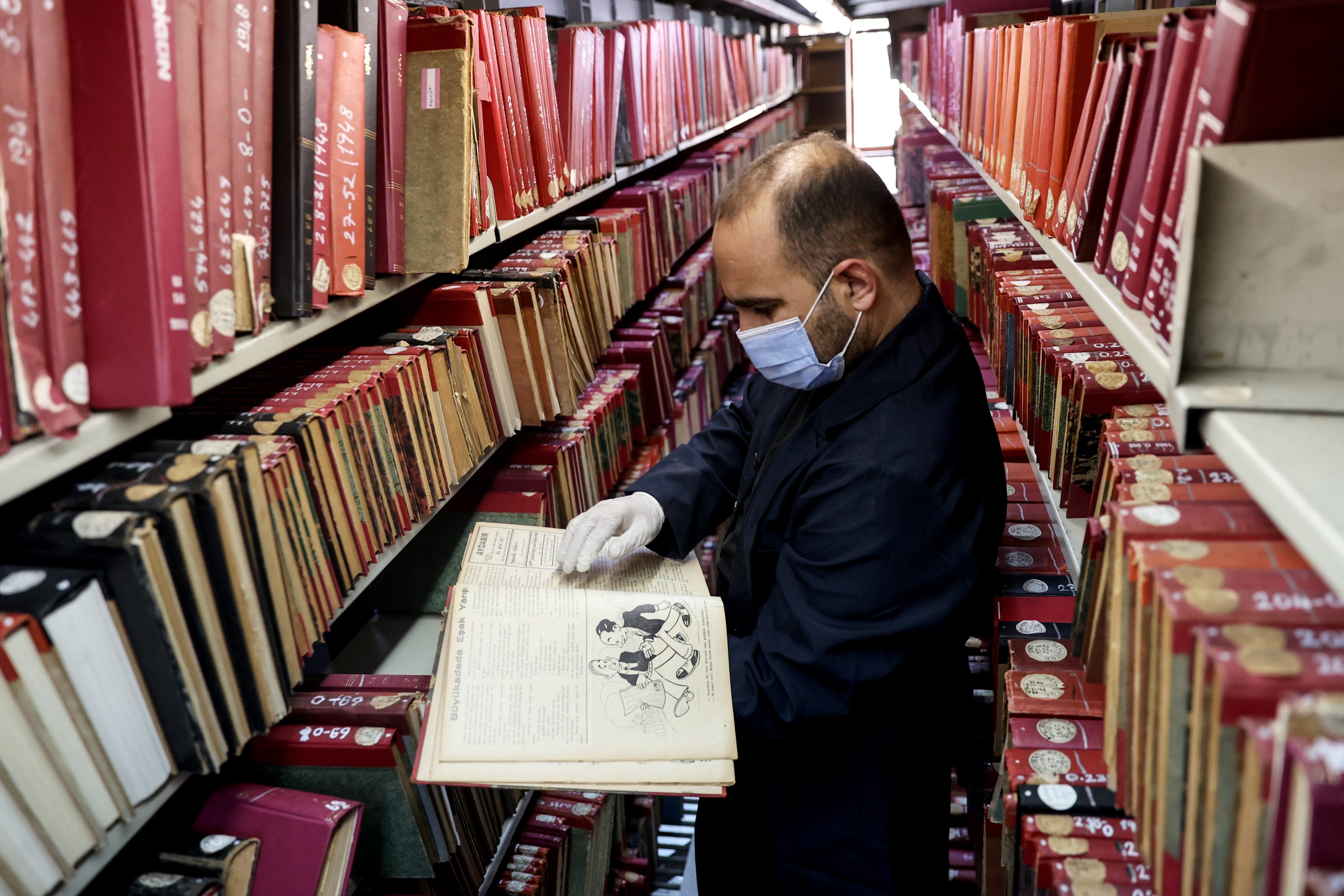 An official shows a book from the archive of Beyazıt State Library, Istanbul, Turkey, March 28, 2020. (AA Photo)