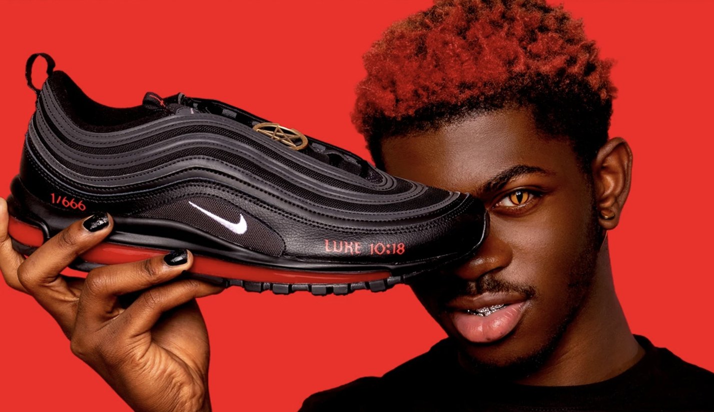 A screenshot of Satanshoes.com shows rapper Lil Nas X holding one of the modified shoes.