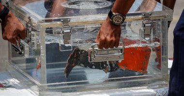 National Transportation Safety Committee (KNKT) officials place the cockpit voice recorder (CVR) of Sriwijaya Air flight SJ 182 on a table at Tanjung Priok Port in Jakarta, Indonesia, March 31, 2021. (Reuters Photo)