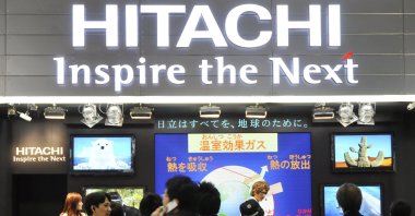Visitors crowd at a booth of Japanese electronics maker Hitachi Ltd. at an ecology fair in Tokyo, Japan, Dec. 11, 2008. (AP Photo)