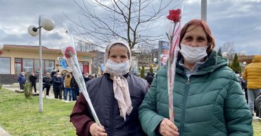 Two women hold carnations given by DPS members as they meet with the Turkish community ahead of the elections, Kirkovo, Bulgaria, March 30, 2021. (AA Photo)
