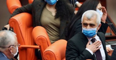 Turkish member of Parliament for the Peoples' Democratic Party (HDP) Omer Faruk Gergerlioglu (R) reacts after he was dismissed following a vote at Parliament, in Ankara, Turkey, March 17, 2021. (AFP Photo)