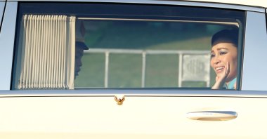 Thailand's Queen Suthida waves inside a car as the motorcade drives towards the Grand Palace in Bangkok, Thailand, Oct. 14, 2020. (Reuters Photo)
