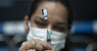 A health care worker prepares a dose of the Pfizer COVID-19 vaccine at the Victor Jara Stadium in Santiago, Chile, March 30, 2021. (AP Photo)