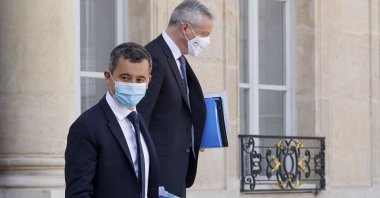 French Interior Minister Gerald Darmanin (L) and French Economy and Finance Minister Bruno Le Maire, wearing protective face masks, leave after a weekly Cabinet meeting at The Elysee Presidential Palace in Paris, France, March 31, 2021. (AFP Photo)