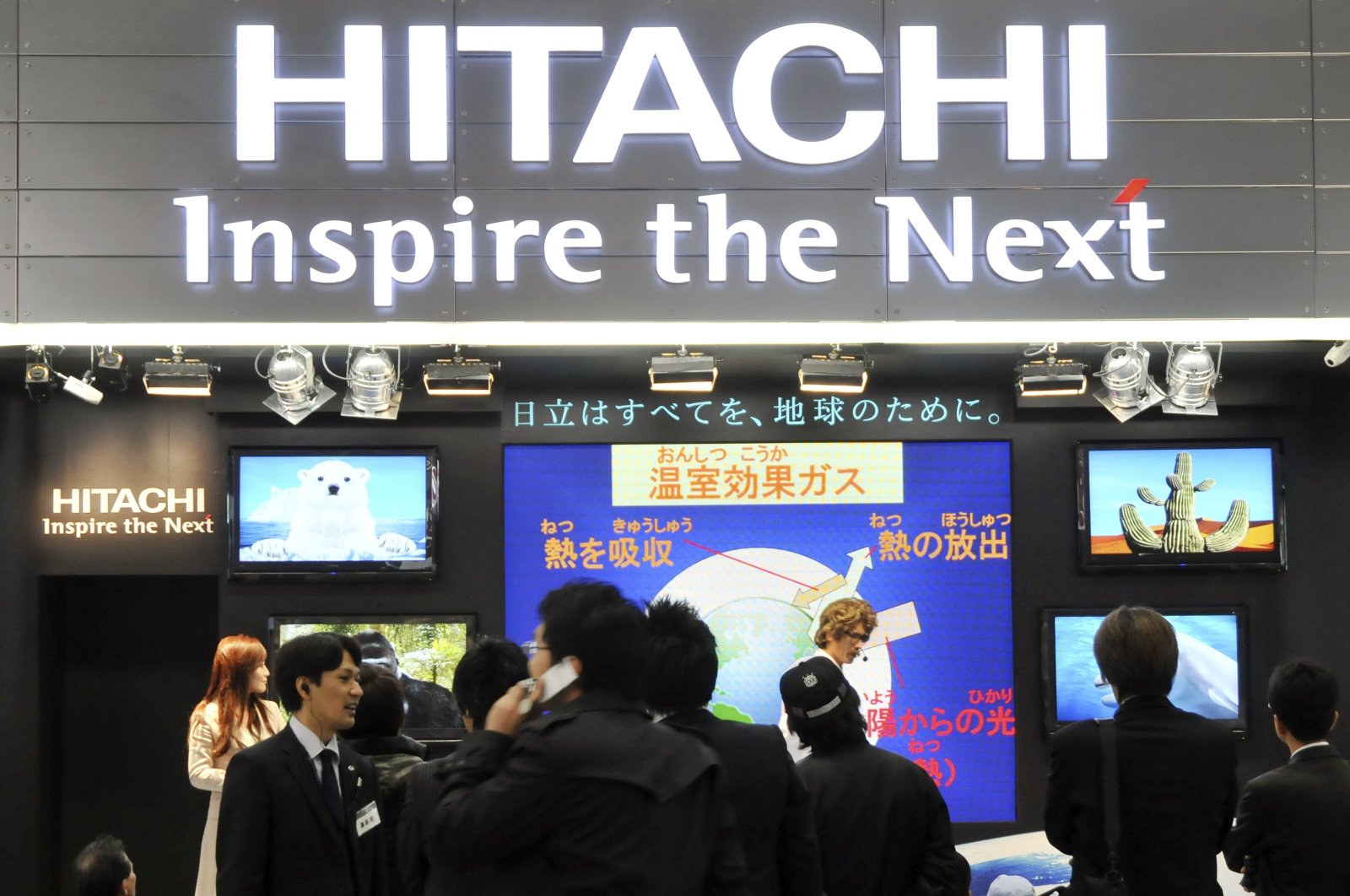 Visitors crowd at a booth of Japanese electronics maker Hitachi Ltd. at an ecology fair in Tokyo, Japan, Dec. 11, 2008. (AP Photo)