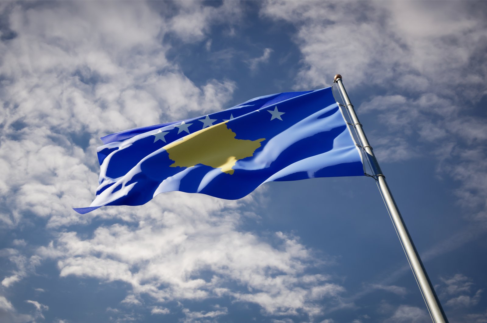 In this undated photo the national state flag of Kosovo flutters against the blue sky. (Shutterstock Photo)