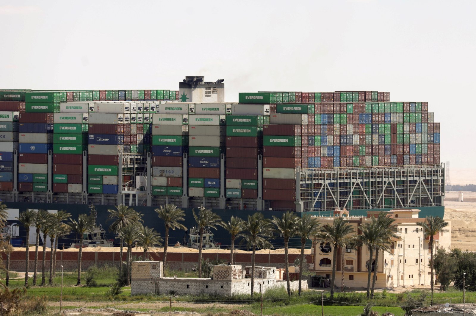 The ship Ever Given, one of the world's largest container ships, passes by a house after it was partially refloated in Suez Canal, Egypt, March 29, 2021. (Reuters Photo)