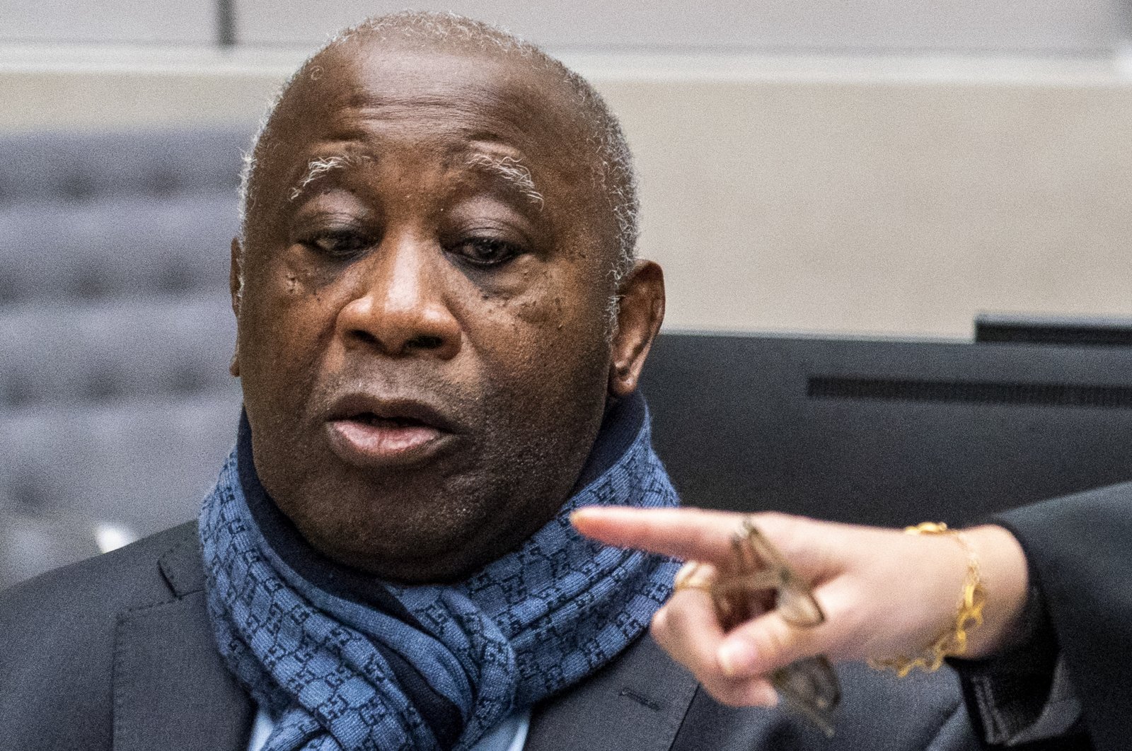 Former Ivory Coast president Laurent Gbagbo watches computer screens at the International Criminal Court in The Hague, Netherlands, Feb. 6, 2020. (AP Photo)