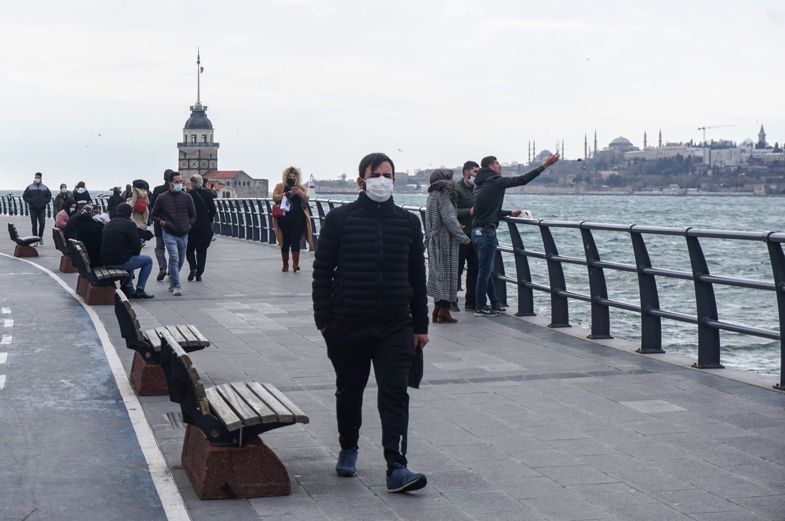 A man wearing a facemask as a precaution against the spread of COVID-19 walks by the seaside in the Üsküdar neighborhood of Istanbul, Turkey, March 16, 2021. (Reuters Photo)